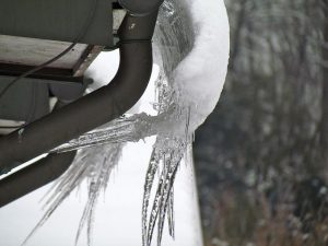Frozen Arkansas gutter winter damage